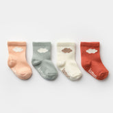 Set of four cloud baby socks in peach, sage, cream, and terracotta tones